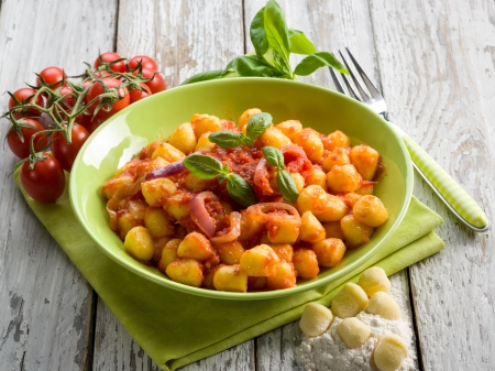 homemade gnocchi with tomato sauce basil and onionsの写真素材