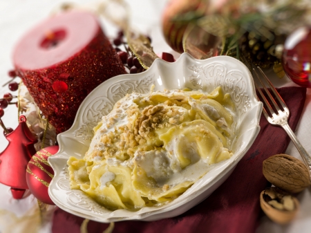 ravioli with cream and walnut on christmas tableの写真素材
