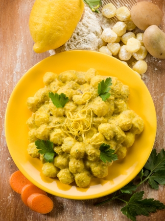 gnocchi with ricotta carrot and lemon peel, vegetarian foodの写真素材