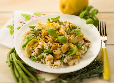 barley risotto with mushroom artichoke white meat and green beansの写真素材
