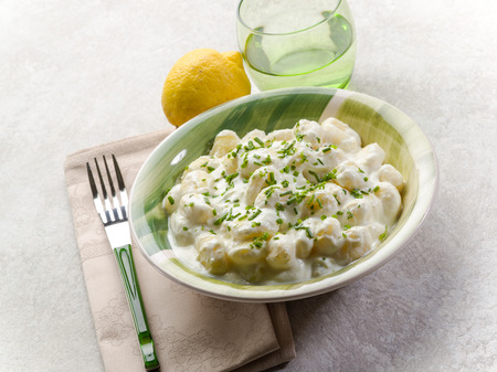 gnocchi with chive cream sauce and grated lemonの写真素材