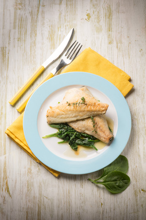fish fillet with fresh spinachの写真素材