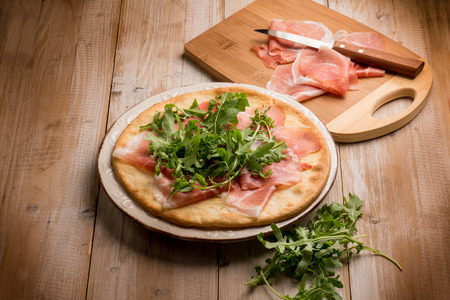 pizza with parmesan ham and arugulaの写真素材