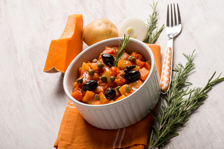 ratatouille with pumpkin capers potatoes and black olivesの写真素材