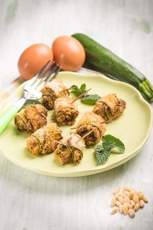 filled rolled up zucchinis with pine nuts, selective focusの写真素材