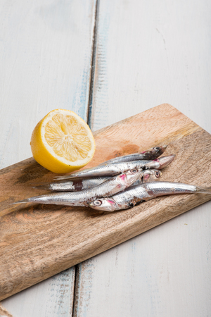 raw anchovies and sliced lemonの写真素材
