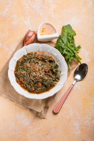 oriental spinach with sesame seed tomato and honey sauceの写真素材
