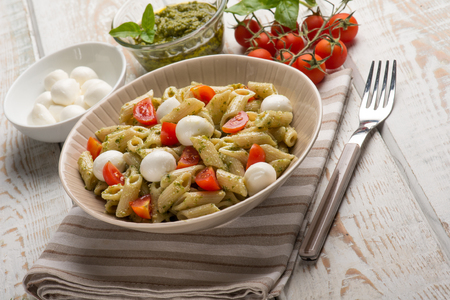 cold pasta salad with mozzarella and pesto sauceの写真素材