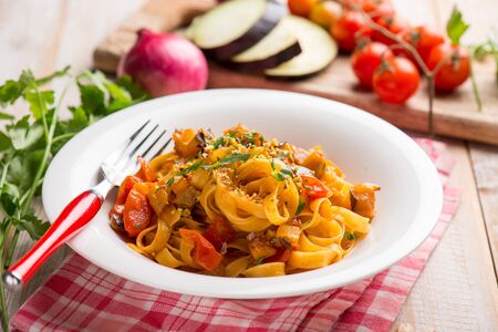 tagliatelle pasta with eggpalnts and fresh tomatoesの写真素材