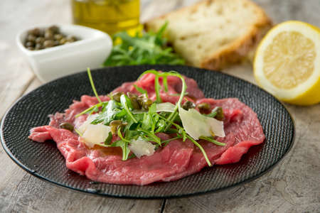 beef carpaccio with arugula capers and parmesan cheeseの写真素材