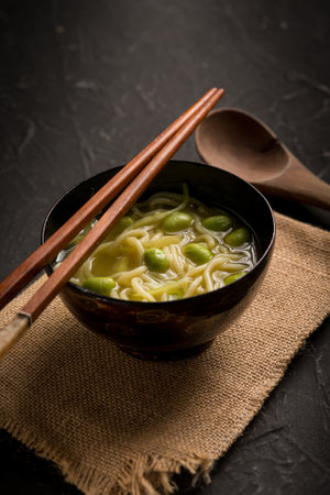 japanese soup with noodles and edamameの写真素材