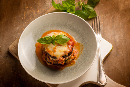 eggplants parmigiana with basil leaves, traditional italian recipeの写真素材