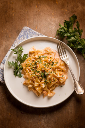 butterfly pasta with smoked salmon cream sauce and parsleyの写真素材