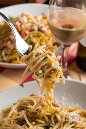 hand with fork rolling spaghettiの写真素材