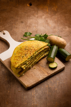 zucchini potatoes homemade crepes over cutting boardの写真素材