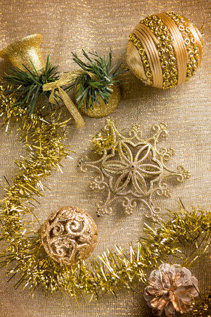 gold christmas decoration over gold backgroundの写真素材