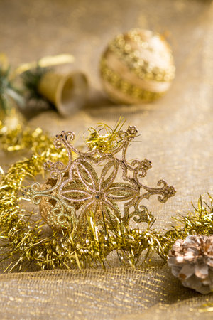 gold christmas decoration over gold backgroundの写真素材