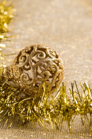 gold christmas decoration over gold backgroundの写真素材