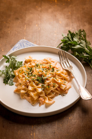 butterfly pasta with smoked salmon cream sauce and parsleyの写真素材