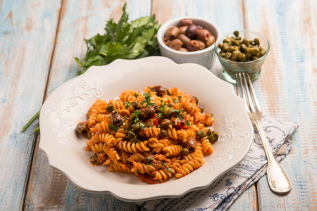 pasta with tuna tomatoes capers and black olivesの写真素材