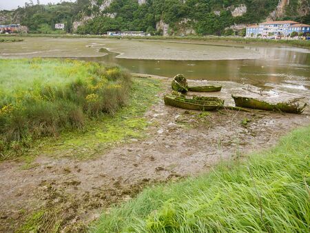 dry river leaves uncovered sunken boats now destroyedの写真素材