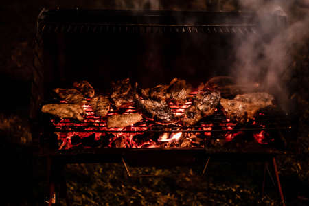 Blazing chicken barbecue and smokeの写真素材