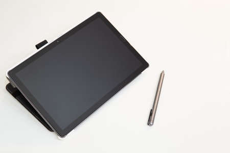 Tablet on a table with touchscreen penの写真素材