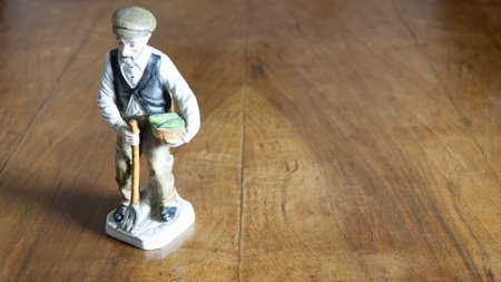 Nativity figurine of farmer on a wooden backgroundの写真素材