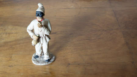 Nativity scene figurine of Pulcinella on a wooden backgroundの写真素材