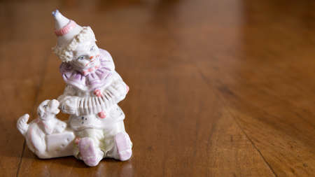 Ceramic Pierrot figurine with dog and accordionの写真素材