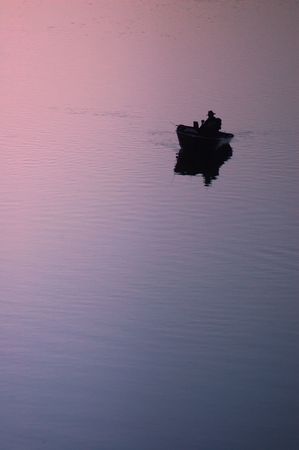 Lone fisherman on riverの写真素材