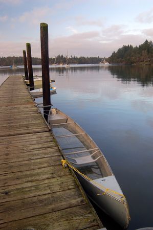 Dhingis tied up at pierの写真素材