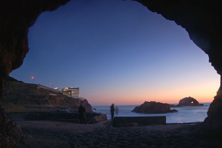 people watching the sunset from the cave enterance, near the cliffhouse resturant in San Franciscoの写真素材