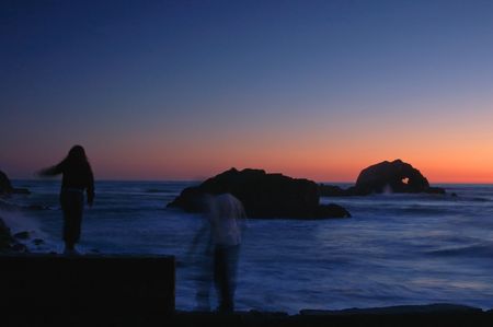 people watching the sunset on the beachの写真素材