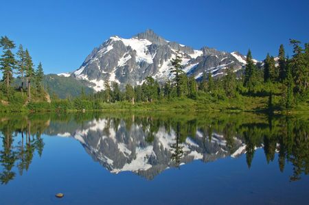 Mountain peak reflected on a lake in the North Cascade mountains of Washington Stateの写真素材