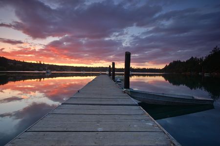 sunset on Matsmats harbor in Puget Sound with boats tied to the dockの写真素材
