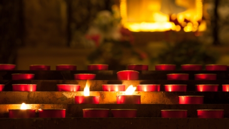 candles with flame inside a church in Italyの写真素材