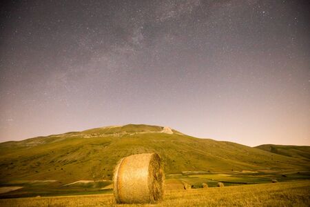 Photo for Starry sky and Milky Way in the plain of Castelluccio di Norcia. Apennines, Umbria, Italy - Royalty Free Image