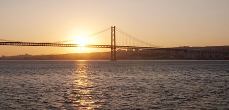 Bridge 25 de Abril on river Tagus at sunset, Lisbon, Portugal