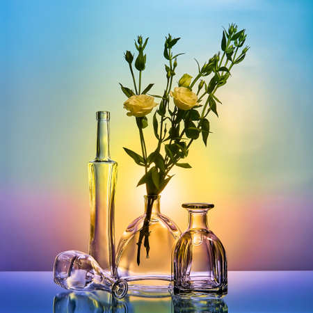 still life with glass bottles and flowersの写真素材