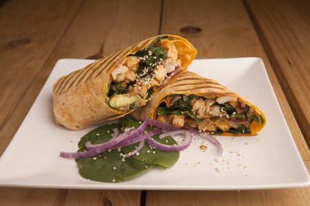 Chicken wrap on a wooden tableの写真素材
