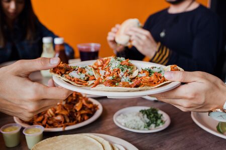 Mexican People eating Tacos al Pastor in a Taqueria in Mexico