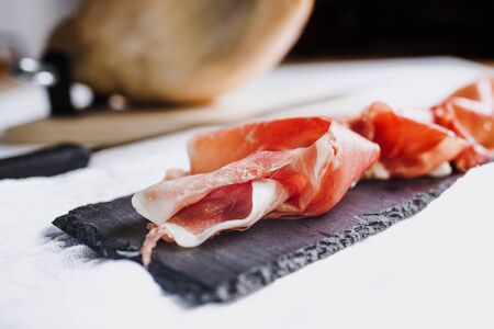 Serrano ham. Traditional Spanish ham, Slicing of dry-cured ham in Spainの写真素材
