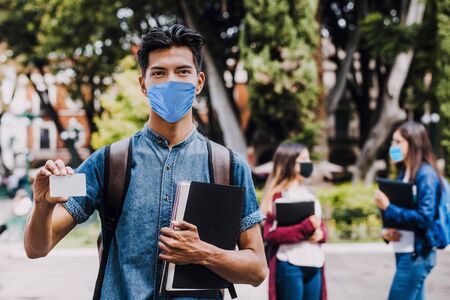 mexican student wearing mask face to prevent infection or respiratory illness, Mexican man with Protection against contagious coronavirus in Mexico Latin Americaの写真素材