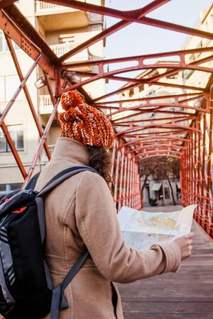 woman tourist looking at the map on a bridge of european city, travel to Europeの写真素材
