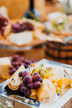 cheese board and grapes, salami and crackersの写真素材