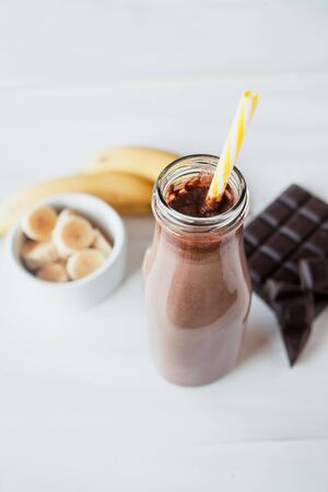 Banana and chocolate smoothie in the glass jar milkshakes, natural and organic drinkの写真素材