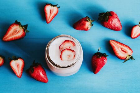 Strawberry milkshake in the glass jar blue vintage backgroundの写真素材