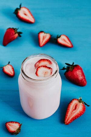 Strawberry milkshake in the glass jar blue vintage backgroundの写真素材