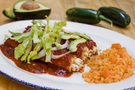 Mexican enchiladas rojas with chicken lettuce and onions Food in Mexicoの写真素材
